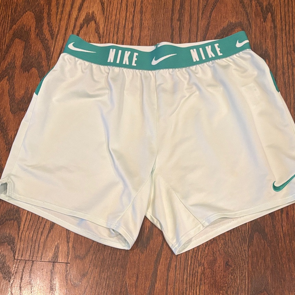 Nike girls running shorts. Size medium. Mint green with teal trim.